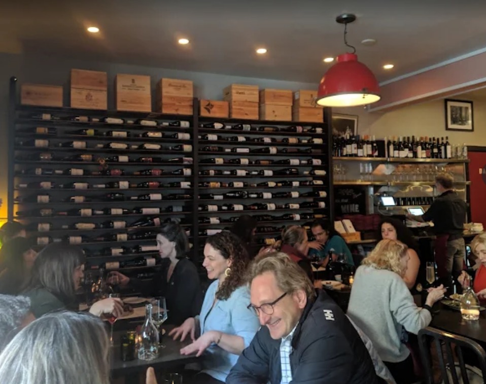 InoVino wine bar interior — wine wall and guests in Cole Valley